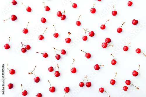 Fresh cherries scattered on white background. Top view.