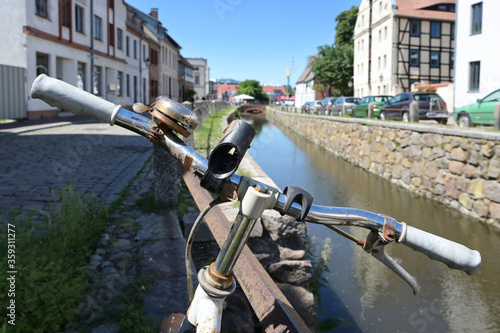 Old bicycle at the canal in the old town of Wismar, the Hanseatic city is a famous tourist destination at the Baltic Sea