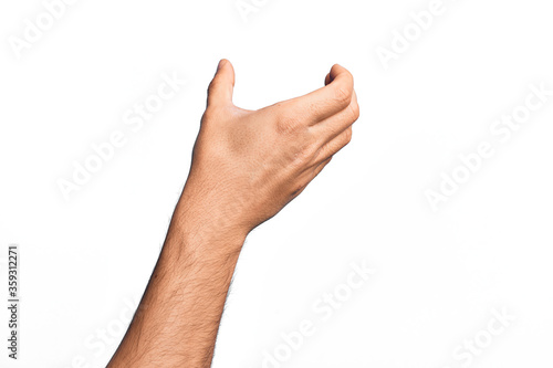 Hand of caucasian young man showing fingers over isolated white background holding invisible object, empty hand doing clipping and grabbing gesture photo