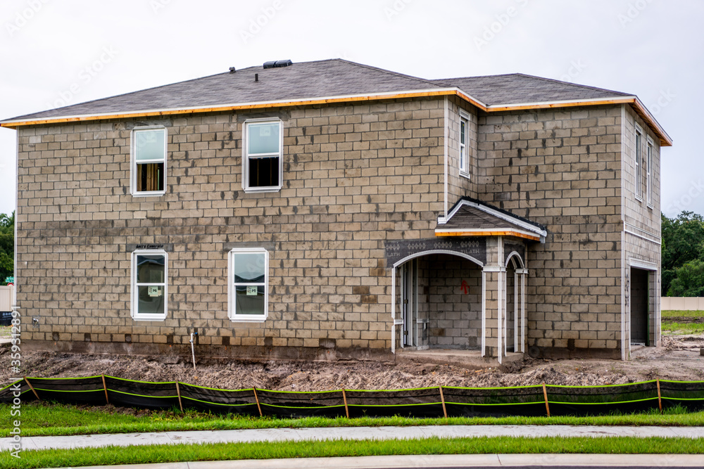 Fototapeta premium New home construction in west-central Florida from foundations, blockwork, framing, electrical, plumbing, HVAC, and setting trusses.