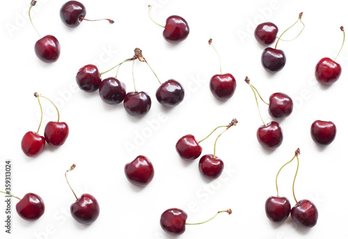 Ripe sweet cherries on a white background. Pattern with ripe sweet cherries