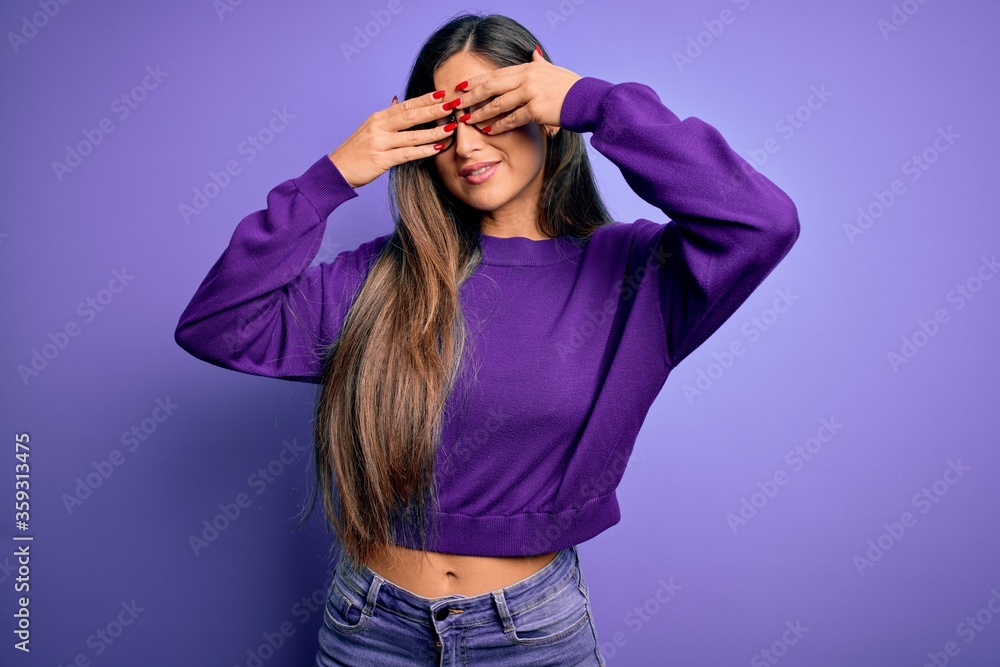 Young beautiful smart woman wearing glasses over purple isolated background covering eyes with hands smiling cheerful and funny. Blind concept. Young beautiful smart woman wearing glasses over purple isolated background covering eyes with hands smiling cheerful and funny. Blind concept.