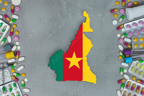 The Cameroon State began research for treatment and medicine to combat the pandemic outbreak disease coronavirus. Medicine, pills, needles, syringes and Cameroon  map and flag on gray background.