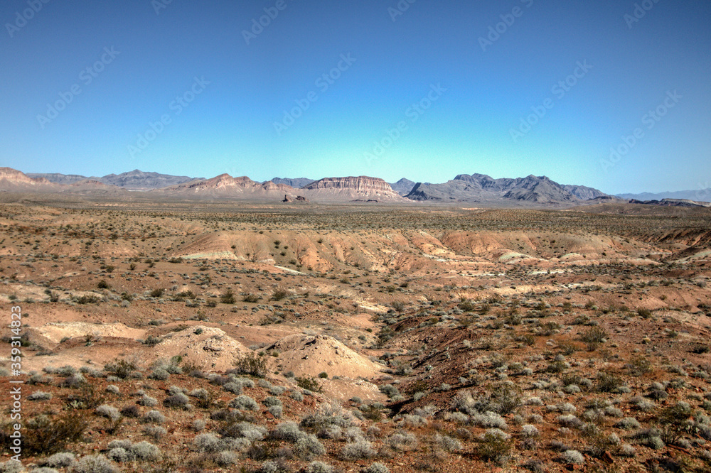 Wild West Desert Landscape. Vast open desert of Nevada with buttes and mountain terrain at the horizon.