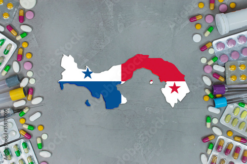 The Panama State began research for treatment and medicine to combat the pandemic outbreak disease coronavirus. Medicine, pills, needles, syringes and Panama map and flag on gray background.