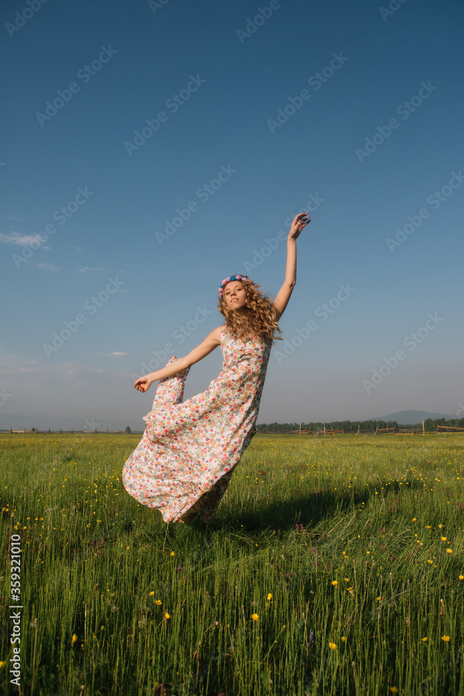 Girl in a dress and a wreath in the field Girl in a dress and a wreath in the field
