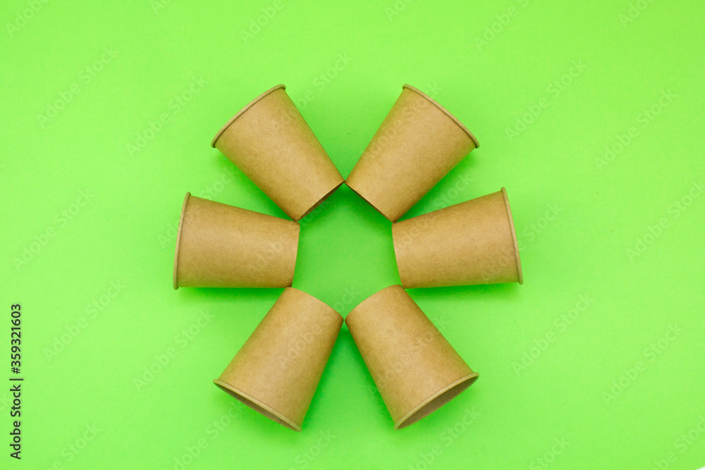Disposable paper cups made from recycled materials. Secondary raw materials and industry. Zero waste concept and environmental protection. Disposable paper cups made from recycled materials. Secondary raw materials and industry. Zero waste concept and environmental protection.