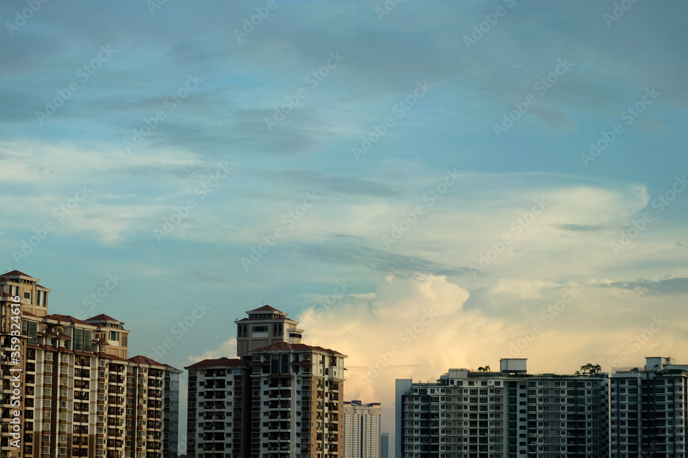 Building with fluffy clouds in the evening