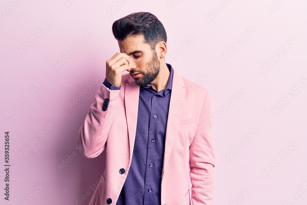 Young handsome man with beard wearing elegant jacket tired rubbing nose and eyes feeling fatigue and headache. stress and frustration concept. Young handsome man with beard wearing elegant jacket tired rubbing nose and eyes feeling fatigue and headache. stress and frustration concept.