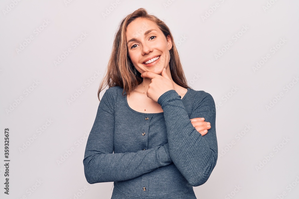 Young beautiful blonde woman standing over white isolated background smiling looking confident at the camera with crossed arms and hand on chin. thinking positive. Young beautiful blonde woman standing over white isolated background smiling looking confident at the camera with crossed arms and hand on chin. thinking positive.