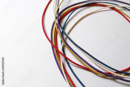 Five colors strings on white background