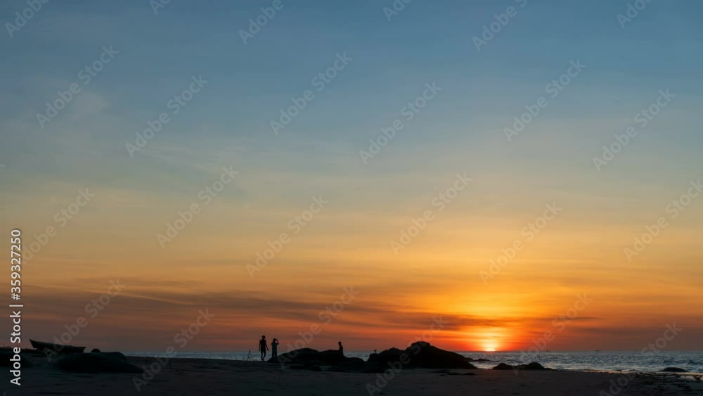 Time lapse: Sunset view on the ocean with reflection and silhouette. A beached foreground log adds interest. Slow motion timelapse 4K footage. Shot at 2160p. Time lapse: Sunset view on the ocean with reflection and silhouette. A beached foreground log adds interest. Slow motion timelapse 4K footage. Shot at 2160p.