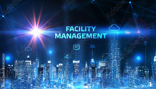 Business, Technology, Internet and network concept. Young businessman shows the word on the virtual display of the future: Facility management