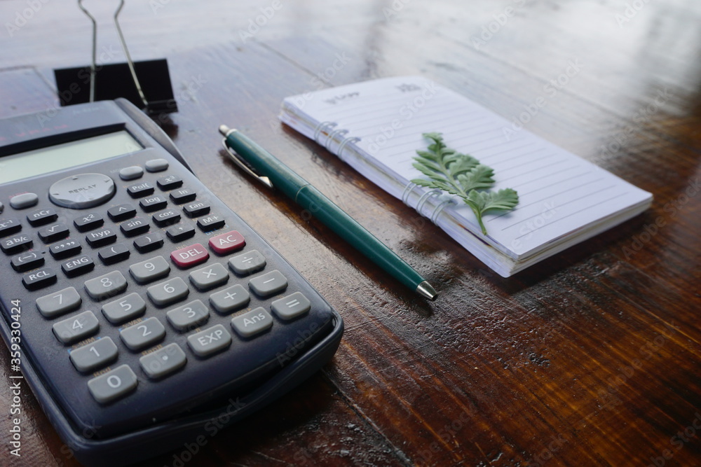 accountant office workspace with notebook, pen and calculator. Outdoor workplace. wooden background vintage accountant office workspace with notebook, pen and calculator. Outdoor workplace. wooden background vintage