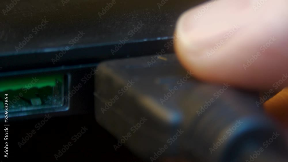 Plugging in a cable into an HDMI port on a laptop MACRO Stock ビデオ