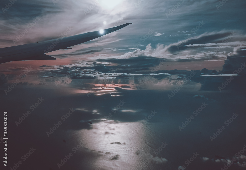 Sunrise above clouds from window of an aircraft Sunrise above clouds from window of an aircraft