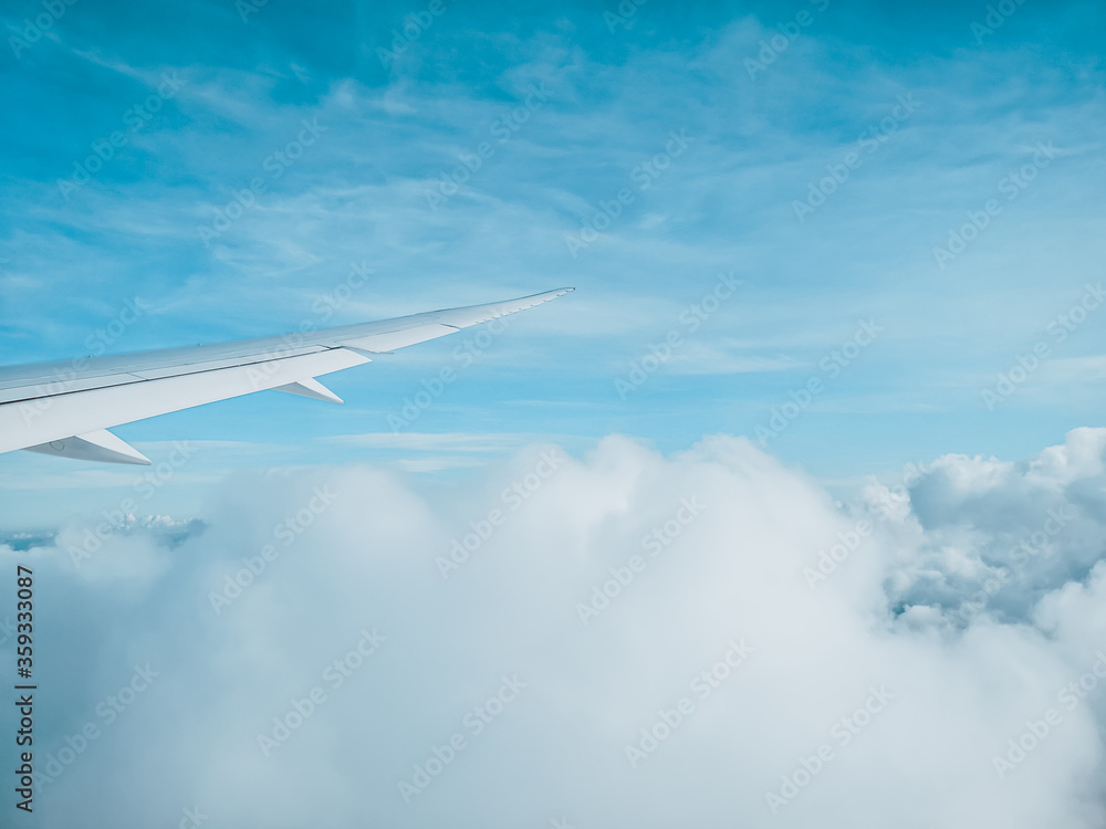 Obraz premium Sunrise above clouds from window of an aircraft