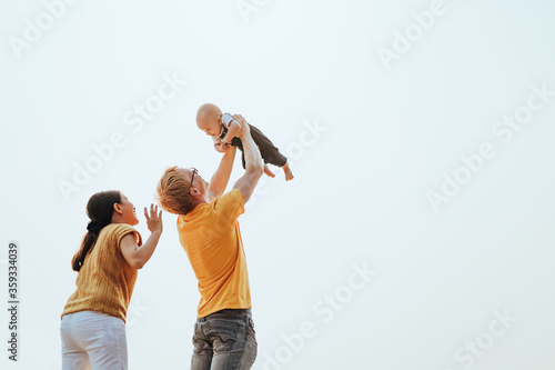 Happy family on the beach. Father, mother and baby having fun on summer vacation. Holiday travel concept