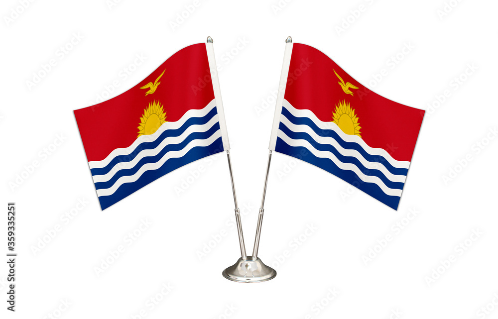 Fototapeta premium Kiribati table flag isolated on white ground. Two flag poles with flags and Kiribati flag on the table.