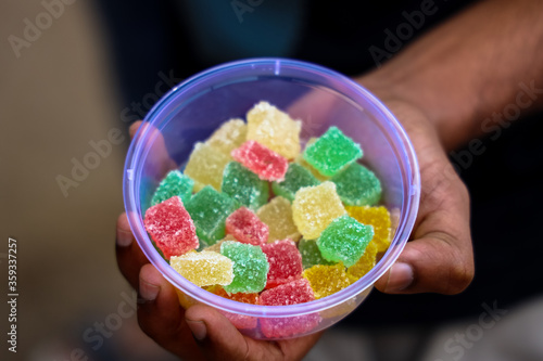 hand holding a colorful candy