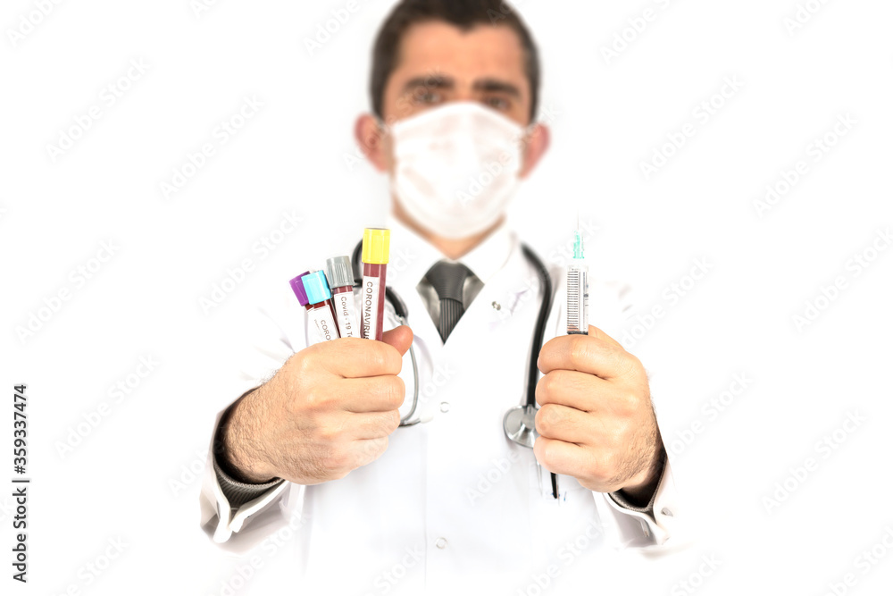 White background, male doctor in a white coat holding coronavirus blood and test tubes and syringe with treatment. White background, male doctor in a white coat holding coronavirus blood and test tubes and syringe with treatment.