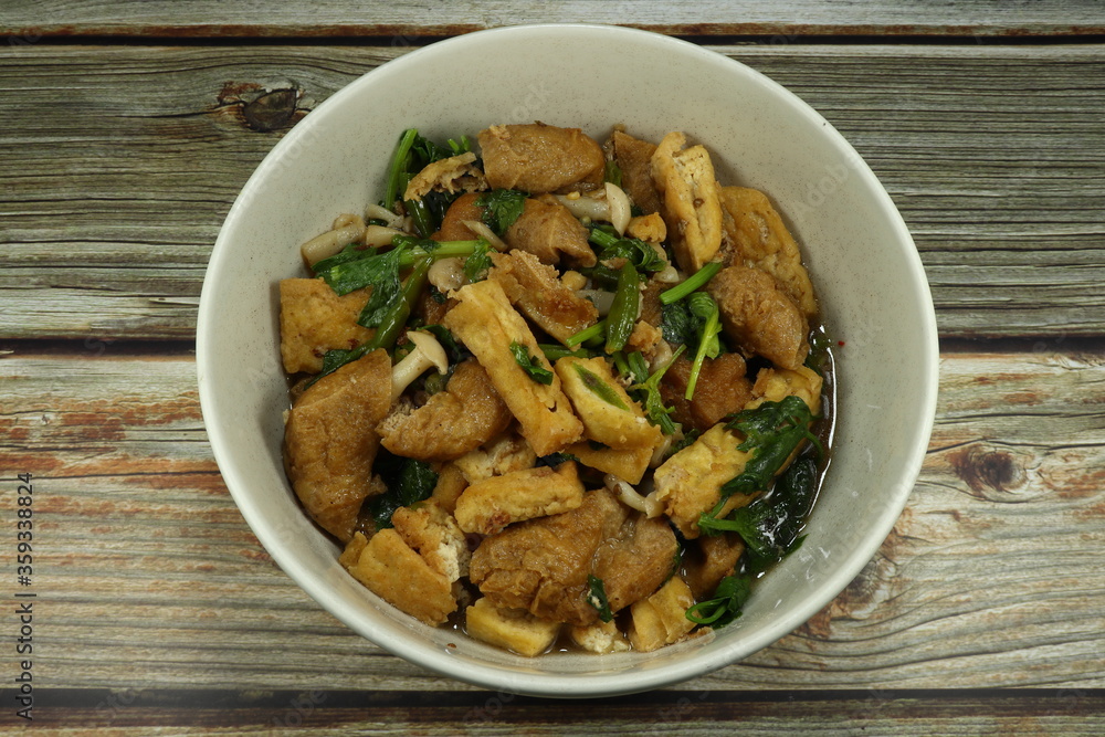 Fried dried tofu with Chinese celery and pepper in the bowl. Famous vegetarian menu in Asia. High protein and fiber food. Diet and low fat menu. Fried dried tofu with Chinese celery and pepper in the bowl. Famous vegetarian menu in Asia. High protein and fiber food. Diet and low fat menu.