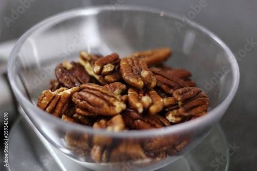 Weighing pecan nuts on kitchen scale