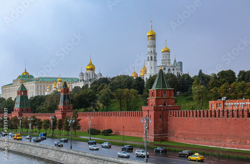 The Kremlin wall, tower and domes of cathedrals blurred in a winter snow storm with snowflakes in the air, Moscow Russia