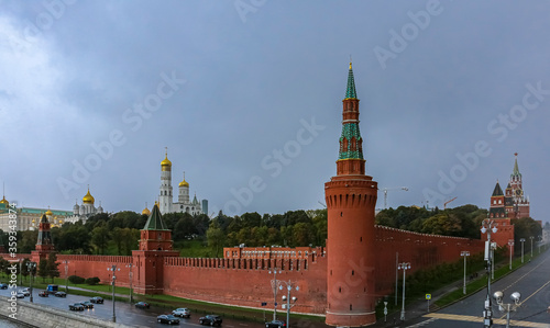 The Kremlin wall, tower and domes of cathedrals blurred in a winter snow storm with snowflakes in the air, Moscow Russia