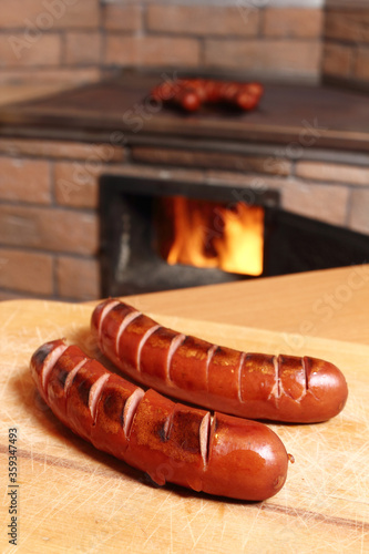 Grilled sausages at masonry oven background photo