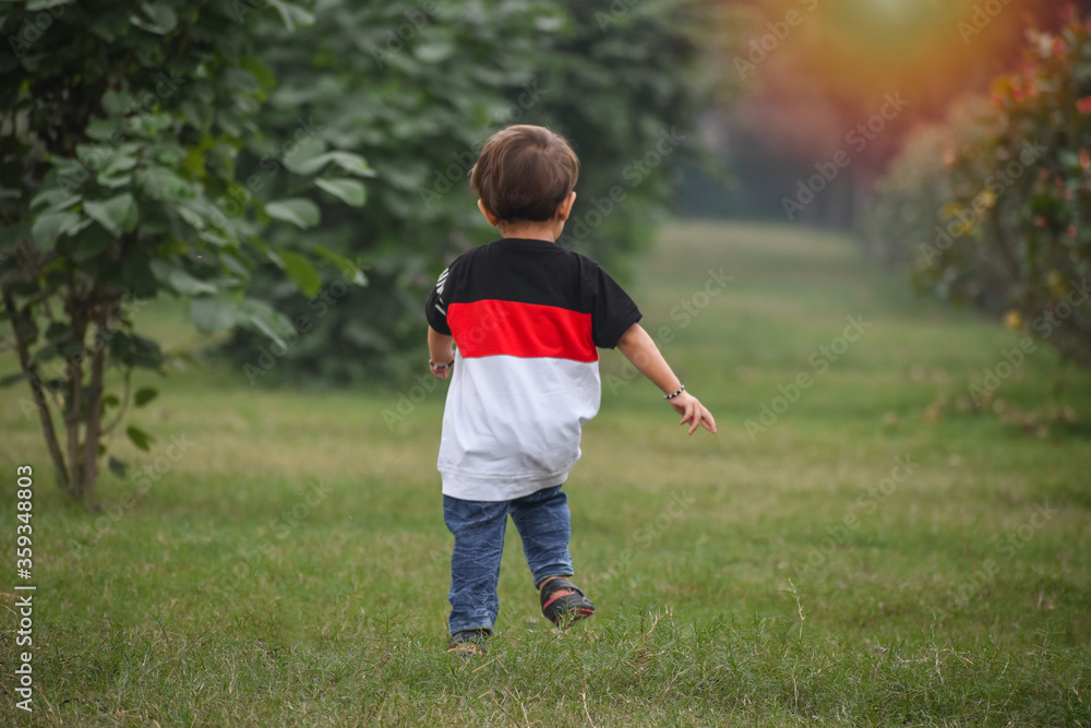 selective focused Beautiful back view of running kid selective focused Beautiful back view of running kid
