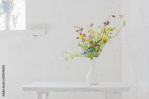 flowers in white vase in white vintage interior © Maya Kruchancova