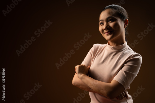 Asian woman happy confident standing crossed arms isolated on beige background.