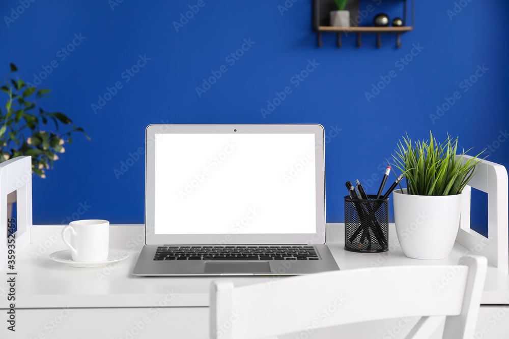 Fototapeta premium Modern workplace with laptop in room