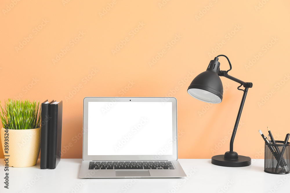 Modern workplace with laptop in room Modern workplace with laptop in room