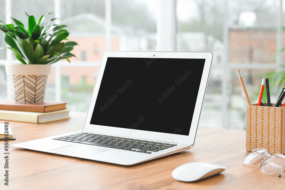 Fototapeta premium Modern laptop at workplace in room