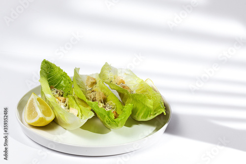 Homemade Caesar salad with chicken, lettuce, lemon, toast, cesar sauce, cheese and garlic