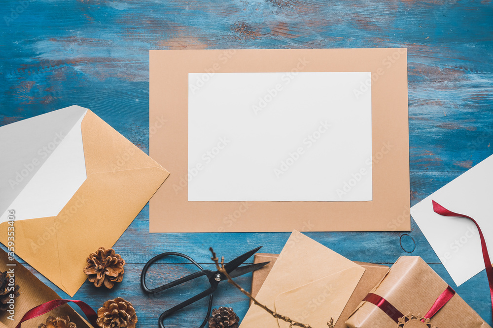 Christmas composition with blank card on color wooden background Christmas composition with blank card on color wooden background