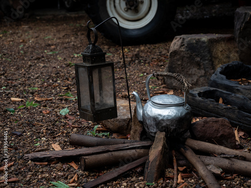 Old kettle on wood in camping outdoor.