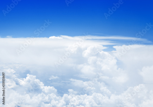 Fototapeta Naklejka Na Ścianę i Meble -  White cumulus clouds on clear blue sky background, aerial cloudscape panoramic view from airplane, high azure skies panorama, fluffy cloud backdrop, sunny heaven, cloudy flight landscape, copy space