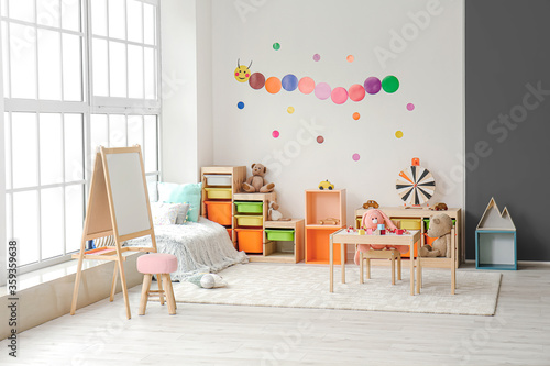 Stylish interior of modern playroom in kindergarten photo