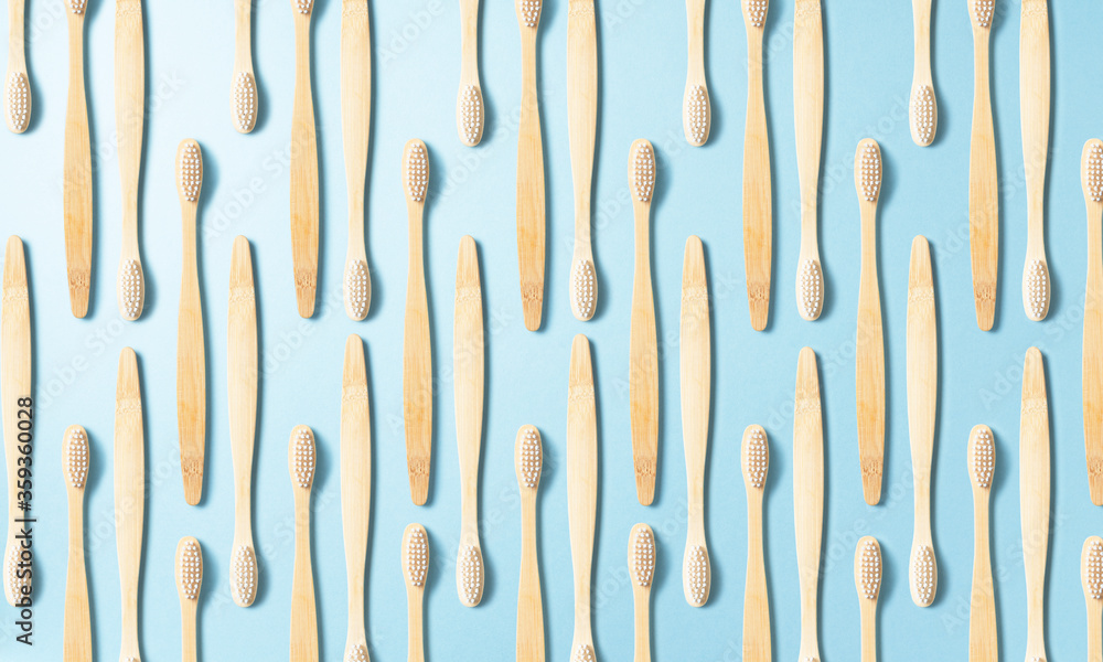 Toothbrushes regularly arranged on a blue background Toothbrushes regularly arranged on a blue background