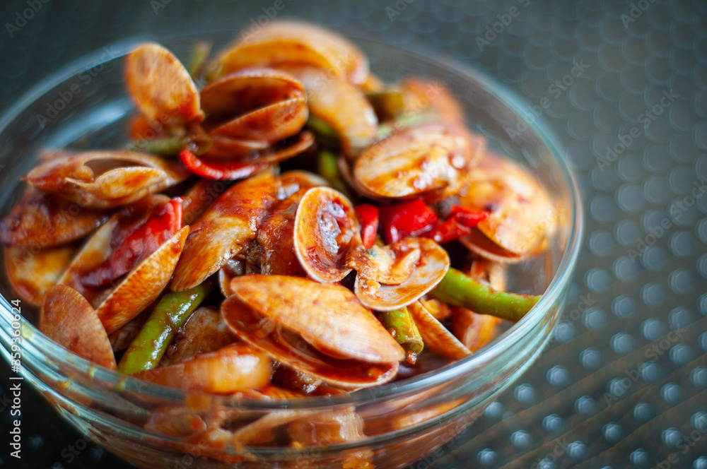 Spicy Paphia textile, or known as retak seribu lala fried with chillies. Served in a bowl. selective focus. Spicy Paphia textile, or known as retak seribu lala fried with chillies. Served in a bowl. selective focus.