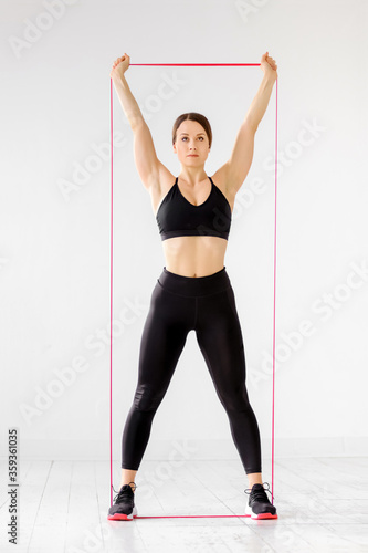 Woman doing a power band press exercise