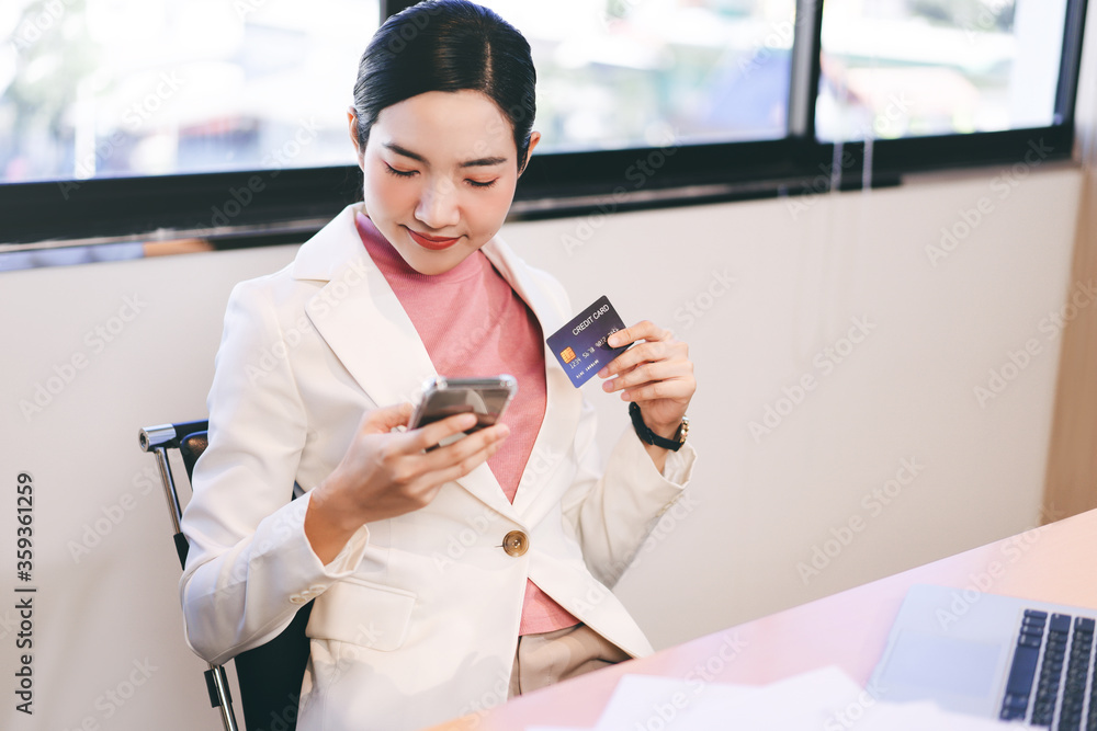 Young asian adult business woman shopping online at office Young asian adult business woman shopping online at office