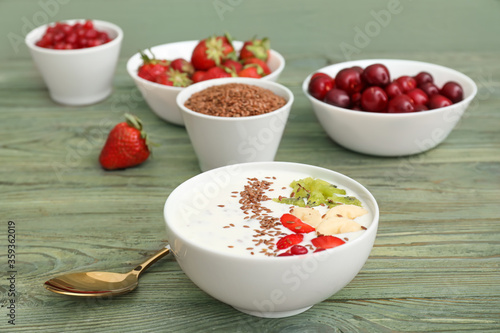 Wallpaper Mural Bowl of yogurt with fruits and flax seeds on wooden background Torontodigital.ca