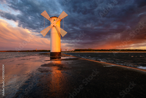 lighthouse in the shape of a windmill in Swinoujscie in Poland during the dramatic sunset