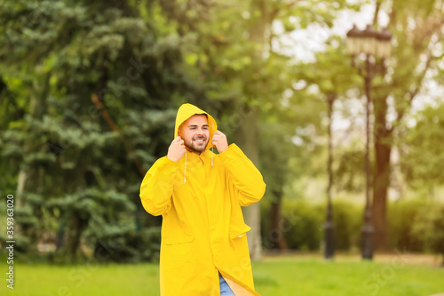 Young man wearing raincoat outdoors