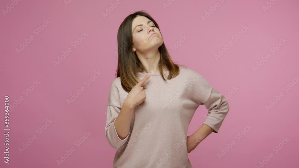 This is me! Proud narcissistic beautiful brunette woman pointing herself and looking with arrogance, feeling famous and selfish in her accomplishments. indoor studio shot isolated on pink background This is me! Proud narcissistic beautiful brunette woman pointing herself and looking with arrogance, feeling famous and selfish in her accomplishments. indoor studio shot isolated on pink background