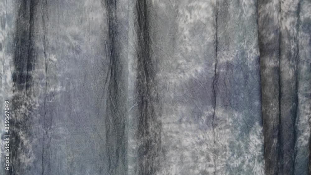 a sheet of blue cloth sways in the wind in a white room a sheet of blue cloth sways in the wind in a white room